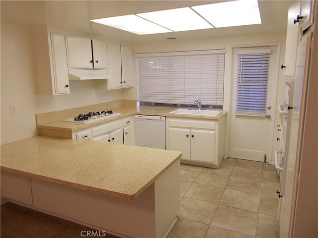 3734 S Marine St, Santa Ana, CA 92704 - kitchen featuring white appliances, a sink, white cabinets, a peninsula, and light countertops