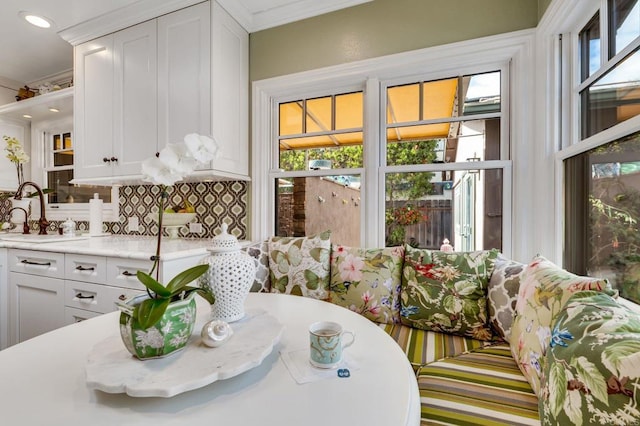 dining room featuring sink and crown molding