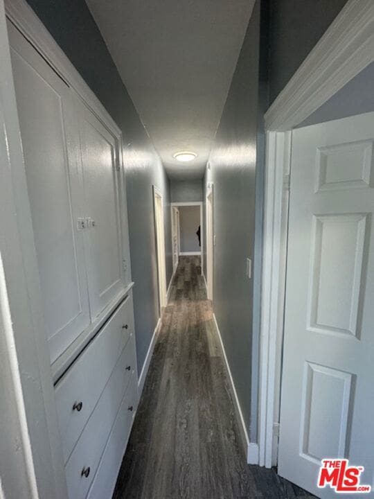 hall with dark hardwood / wood-style floors