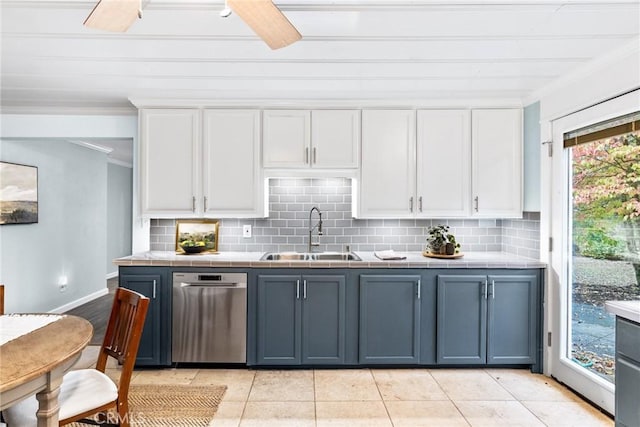 kitchen featuring sink, white cabinets, light tile patterned flooring, and ornamental molding