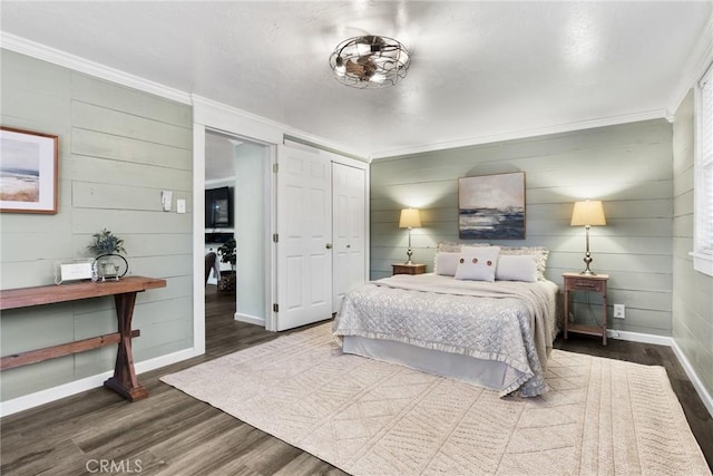 bedroom with a closet, dark wood-type flooring, a textured ceiling, and ornamental molding