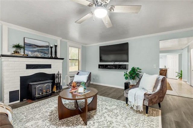 living room with ceiling fan, hardwood / wood-style floors, and ornamental molding