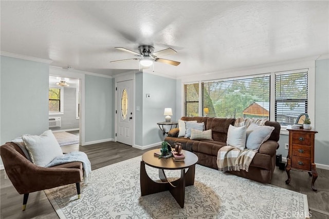 living room with a wall mounted air conditioner, ceiling fan, dark hardwood / wood-style flooring, and crown molding