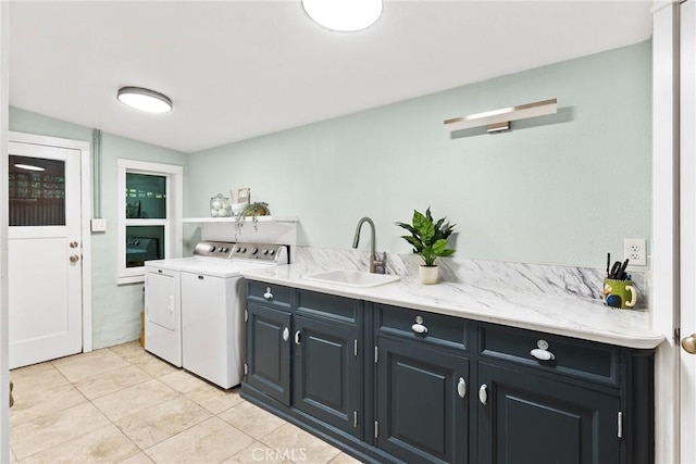 laundry area featuring cabinets, independent washer and dryer, light tile patterned flooring, and sink