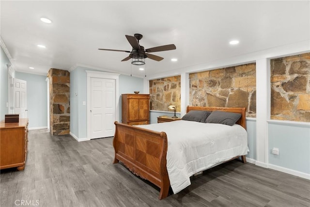 bedroom featuring ceiling fan, dark hardwood / wood-style flooring, and ornamental molding