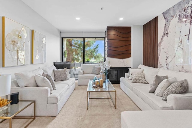 living room with carpet flooring and a premium fireplace