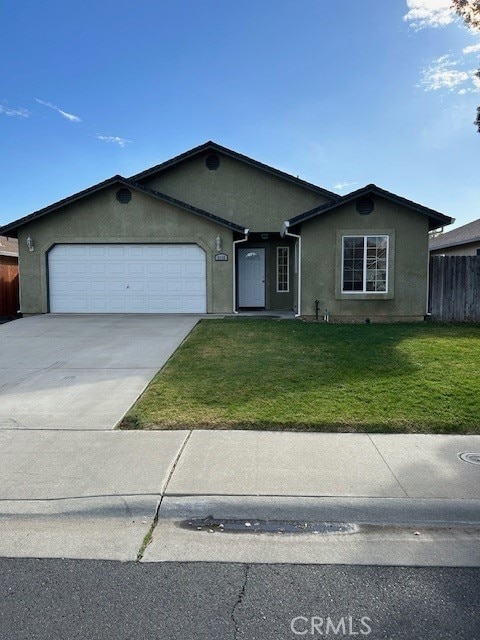 ranch-style house with a front yard and a garage