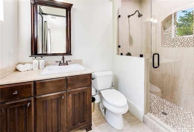 bathroom with toilet, vanity, tile patterned flooring, and a shower with shower door