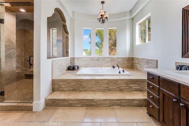 bathroom featuring vanity, plus walk in shower, and a chandelier