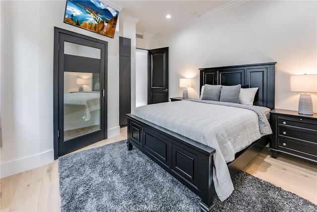 bedroom featuring light wood-type flooring and crown molding