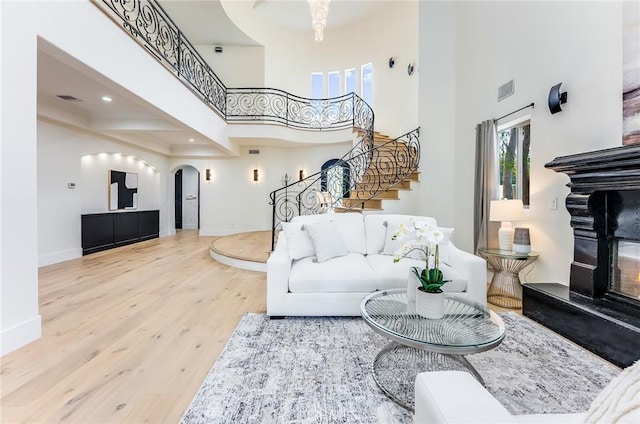 living room with hardwood / wood-style flooring and a high ceiling