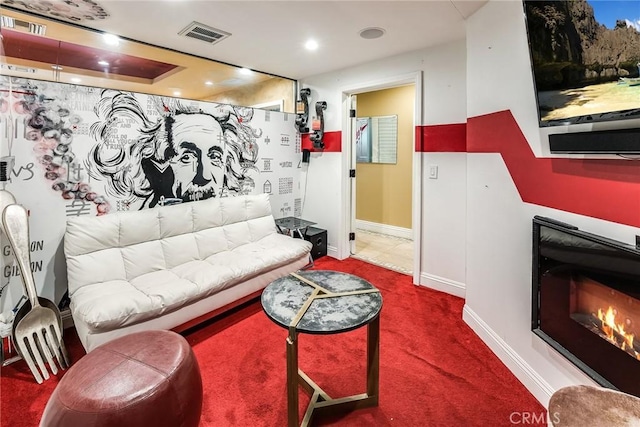 living room with carpet and a tray ceiling