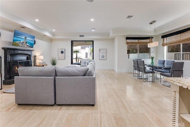 living room featuring crown molding and a tray ceiling