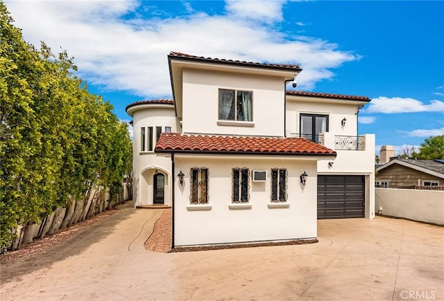 exterior space featuring a garage and a balcony