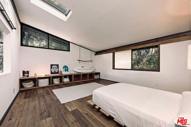 bedroom featuring vaulted ceiling and dark hardwood / wood-style floors