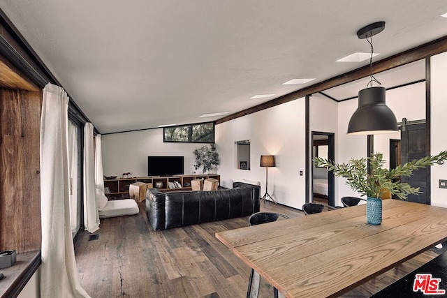 dining space featuring hardwood / wood-style floors and a skylight