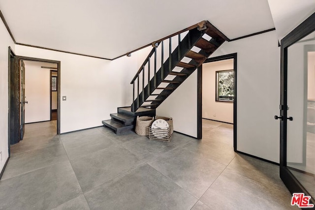 stairway featuring ornamental molding