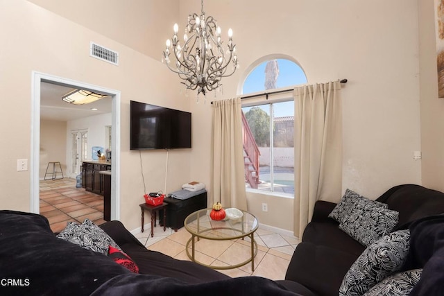 living room featuring light tile patterned flooring and a chandelier