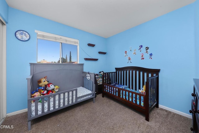 bedroom featuring carpet and a crib