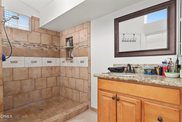 bathroom with a shower, vanity, and backsplash