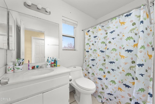 bathroom with a shower with curtain, vanity, toilet, and tile patterned floors