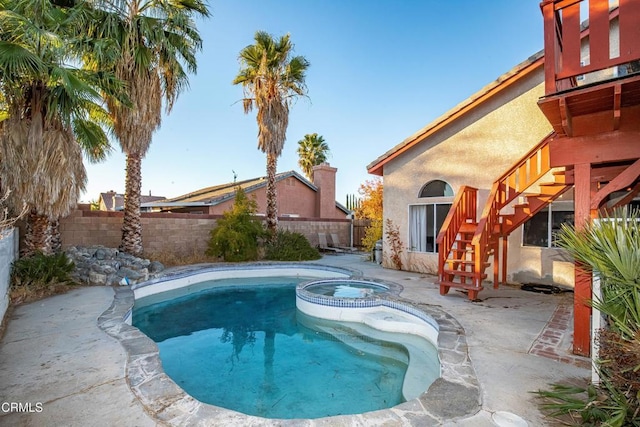 view of swimming pool featuring an in ground hot tub and a patio