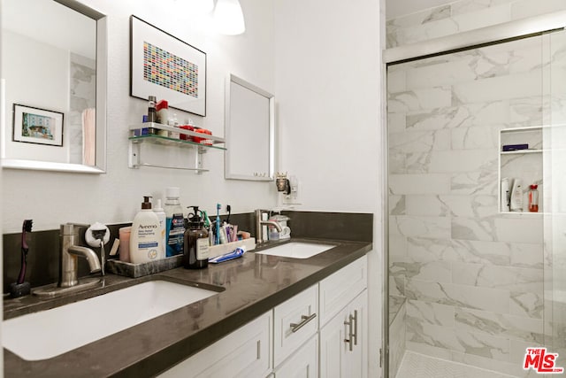 bathroom featuring vanity and a shower with shower door