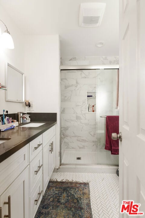 bathroom featuring vanity and walk in shower