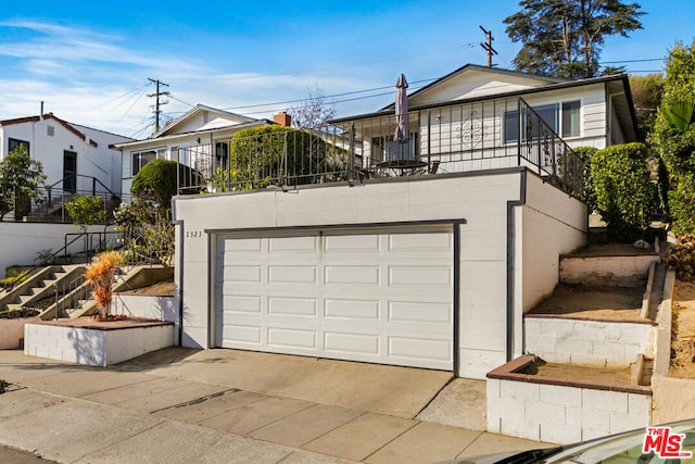 view of front of house with a balcony and a garage