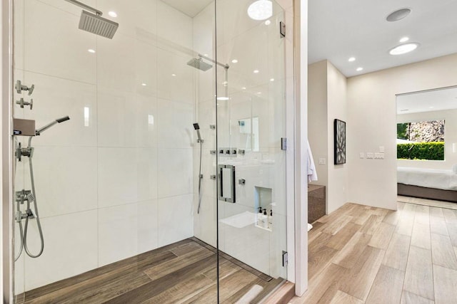 bathroom with wood-type flooring and an enclosed shower