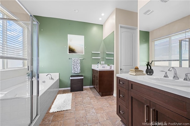 bathroom featuring vanity and separate shower and tub