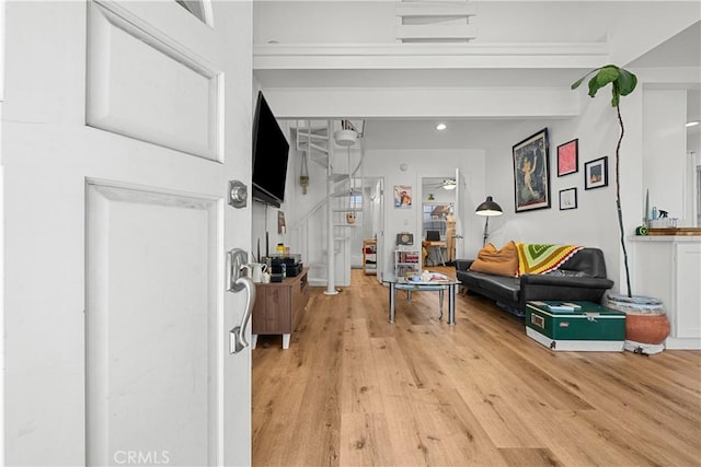 living room with light hardwood / wood-style flooring and ceiling fan