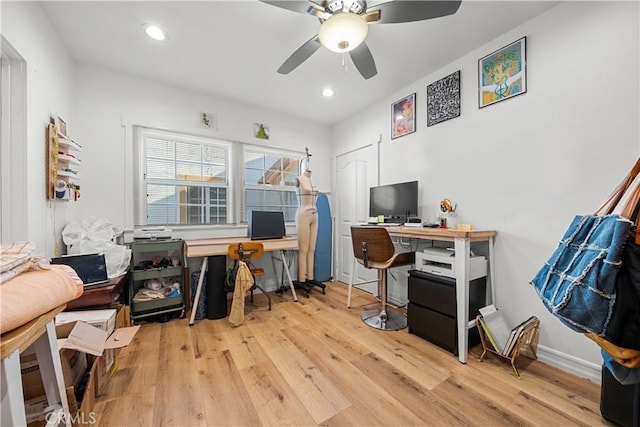 office with ceiling fan and light hardwood / wood-style flooring