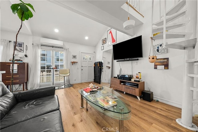 living room with hardwood / wood-style floors, lofted ceiling with beams, and a wall mounted air conditioner