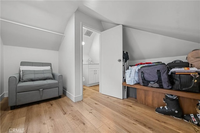 interior space with light hardwood / wood-style floors and lofted ceiling