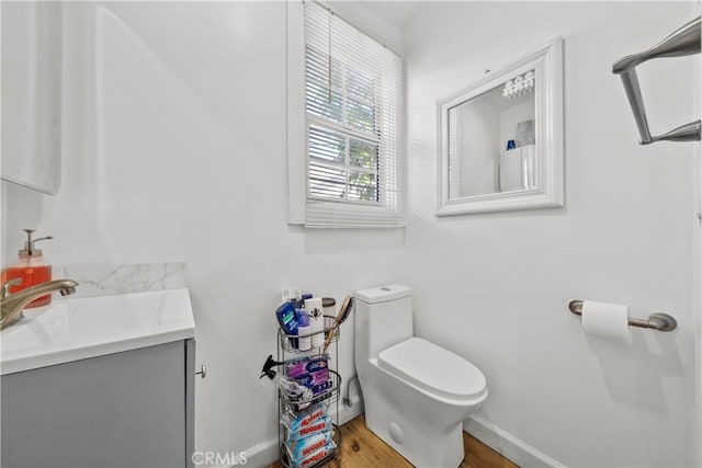 bathroom featuring hardwood / wood-style flooring, vanity, and toilet