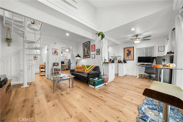 living room featuring ceiling fan and light wood-type flooring