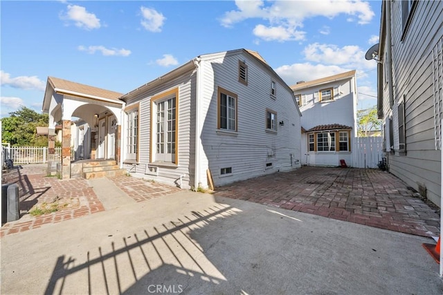 view of side of property featuring a patio