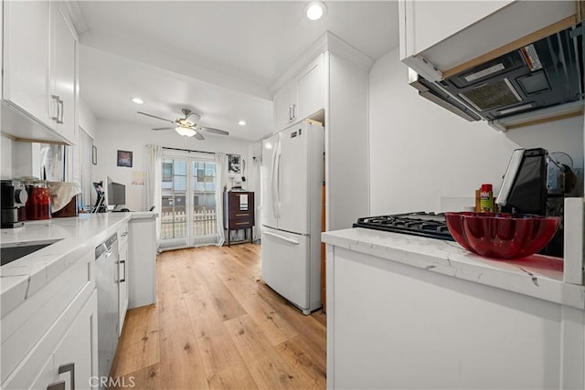 kitchen featuring white cabinets, white refrigerator, stainless steel dishwasher, light hardwood / wood-style floors, and light stone counters