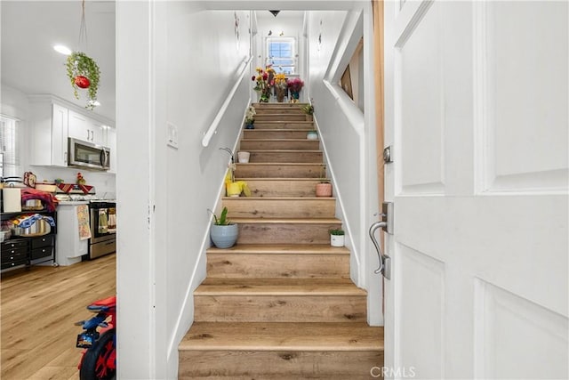 stairway featuring wood-type flooring