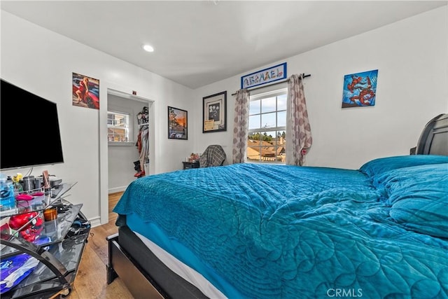 bedroom featuring a spacious closet and a closet