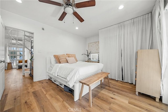 bedroom with ceiling fan and light hardwood / wood-style floors