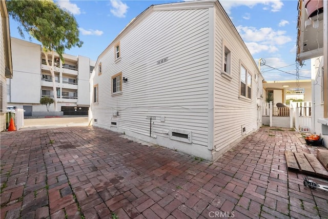 view of side of home with a patio area