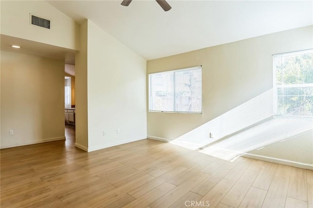 spare room with light hardwood / wood-style flooring, ceiling fan, and lofted ceiling