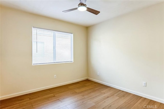 spare room with ceiling fan and light wood-type flooring