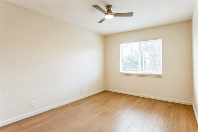 empty room with light hardwood / wood-style floors and ceiling fan