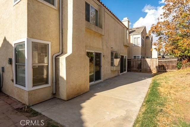 view of side of home with a patio area