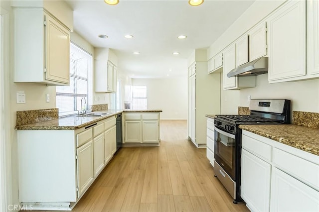 kitchen featuring gas stove, sink, stone countertops, light hardwood / wood-style flooring, and white cabinets