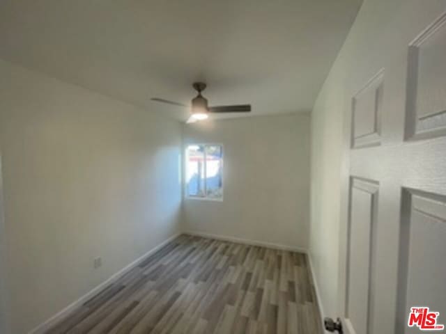 spare room featuring ceiling fan and hardwood / wood-style flooring