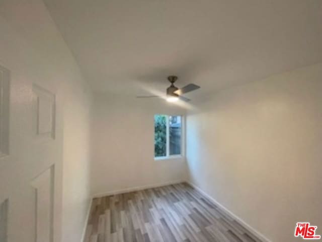 empty room featuring ceiling fan and light hardwood / wood-style floors